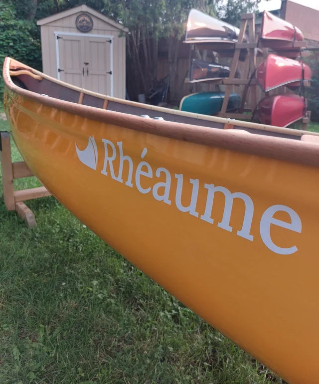 Discounted Rheaume Prospector 16.6 Kevlar Canoe with Wood Trim: Featuring beautiful wood gunwales, this canoe not only performs superbly but also exudes classic elegance. Weighing just 44 lbs, its lightweight Kevlar construction ensures easy handling and transport, enhancing your paddling adventures.